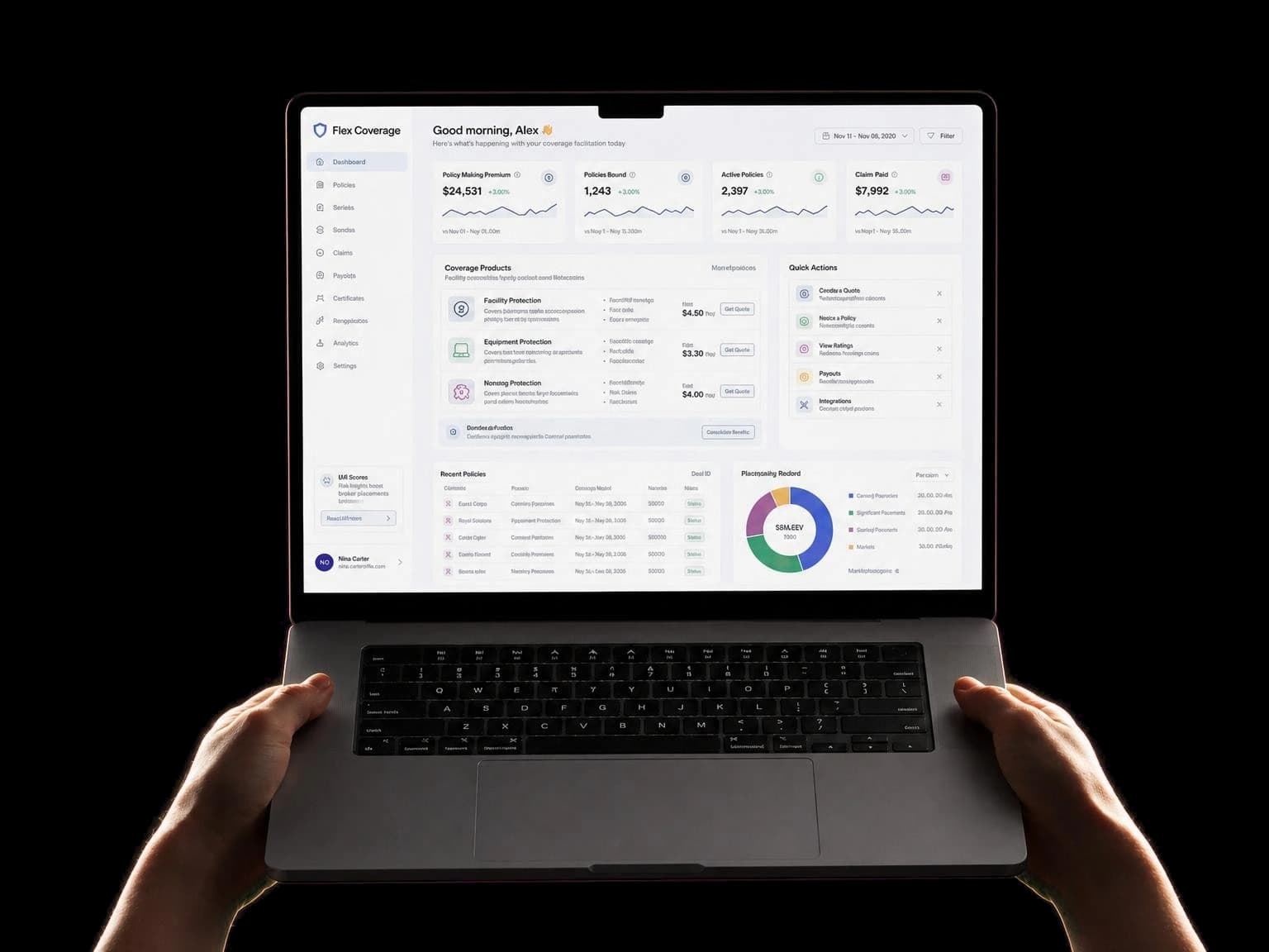 Hands holding an open laptop displaying a custom-built insurance coverage dashboard with premium, policies, claims and payout modules.